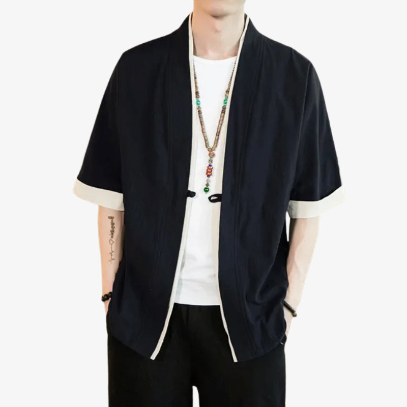 Persona con una chaqueta japonesa negra kimono con ribetes blancos sobre fondo blanco