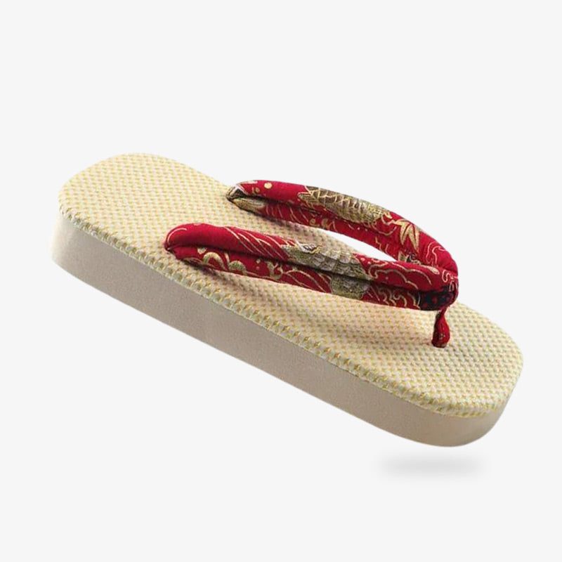 Sandalias zori ligeras, ideales para la playa y los días de verano. La tira hanao es de color rojo con estampado de motivos japoneses. El zori está fabricado con material natural